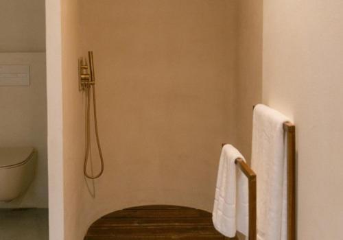 a bathroom with a shower and two towels at Numa Experimental in Pontevedra