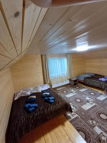 a large room with two beds and a rug at Карпатський котедж Karpatian cottage in Vorokhta