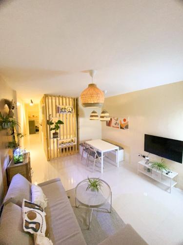 a living room with a couch and a table at Urban Oasis Resort, Tarlac in Tarlac