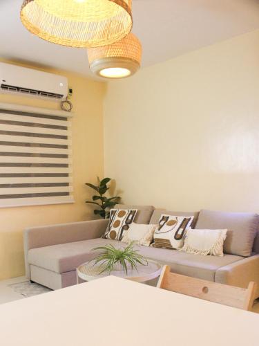 a living room with a couch and a table at Urban Oasis Resort, Tarlac in Tarlac