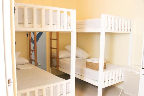 two white bunk beds in a room at Urban Oasis Resort, Tarlac in Tarlac