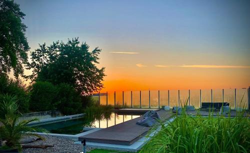 a pool with a dock in the middle of the water at vista-apartments in Ebersbach