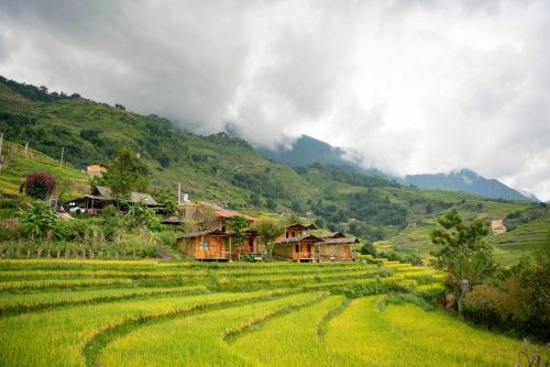 a village in the middle of a green field at SaPa Farmer House in Sa Pa