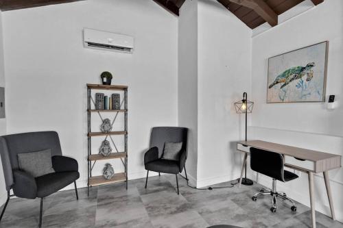 a room with a desk and two chairs and a table at Lovely 1 Bedroom Walking Distance To Ocean - Suite 1 in Hollywood