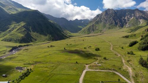 an aerial view of a valley in the mountains at Terkhena in Stepantsminda