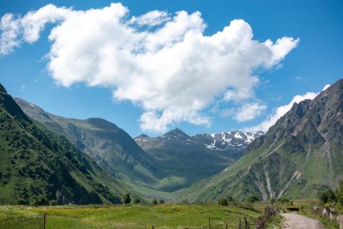 a road through a valley in a mountain range at Terkhena in Stepantsminda
