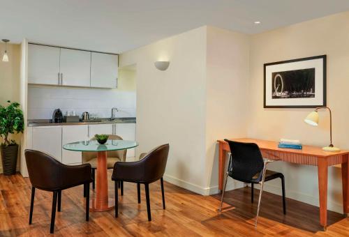 a kitchen and dining room with a table and chairs at Park Plaza Victoria London in London