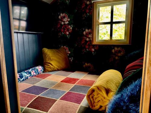 a room with a bed and a window in it at Church House Hut in Melton Mowbray
