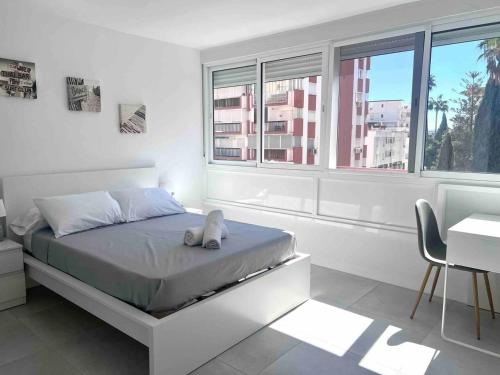 a bedroom with a bed with a stuffed animal on it at Apartamento cerca de la playa, Torre Del Mar in Torre del Mar