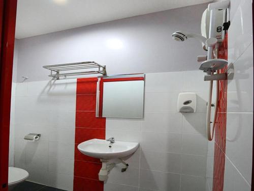 a bathroom with a sink and a toilet and a mirror at Best Hotel Shah Alam @ UITM, i-City & Hospital in Shah Alam