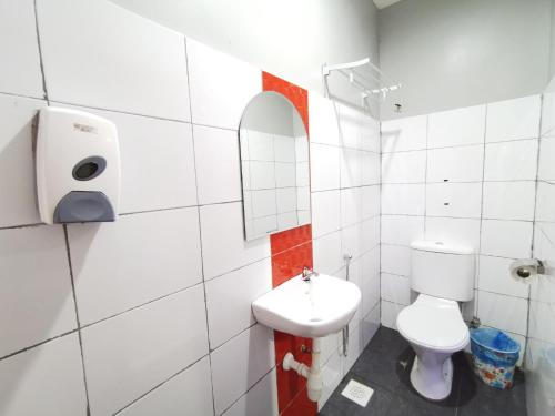 a bathroom with a toilet and a sink at Best Hotel Shah Alam @ UITM, i-City & Hospital in Shah Alam