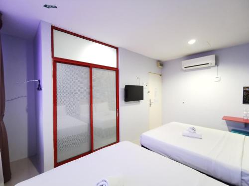 a room with two beds and a window at Best Hotel Shah Alam @ UITM, i-City & Hospital in Shah Alam