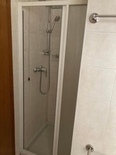a shower with a glass door in a bathroom at Hotel Banatium B&B Cucina in Tezze sul Brenta
