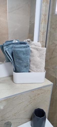 a pile of towels sitting on a shelf in a bathroom at ELIAS LUXURY HOME in Constanţa