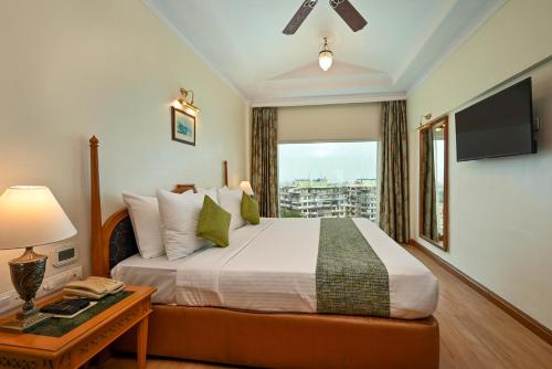 a bedroom with a large bed and a window at Fariyas Hotel Mumbai , Colaba in Mumbai