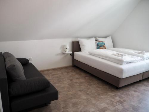 a bedroom with a bed and a couch in it at Haus Sonnenschein in Klagenfurt