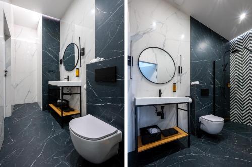 W łazience znajduje się toaleta, umywalka i lustro. w obiekcie Apartamenty Poniatowskiego w mieście Przemyśl