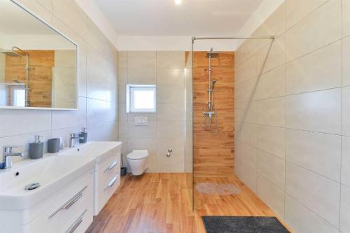 uma casa de banho com um chuveiro, um lavatório e um WC. em Villa Natura with pool, Zadar county em Stankovci