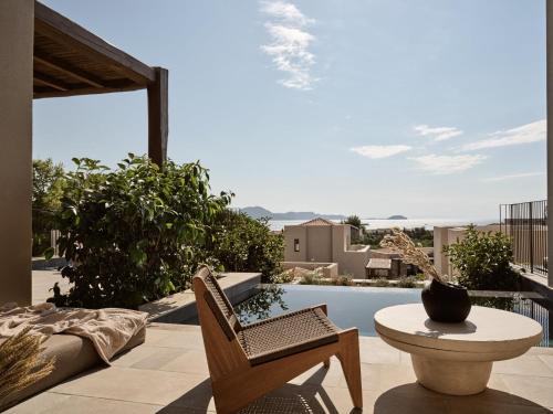 a patio with a table and chairs and a pool at Pierros Verde in Lithakia