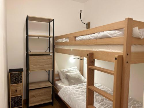 une chambre avec deux lits superposés et un lit dans l'établissement Appartement de Standing 6 Pers. - Résidence Neuve Centre des Gets với Garage et Balcon - FR-1-623-328, aux Gets