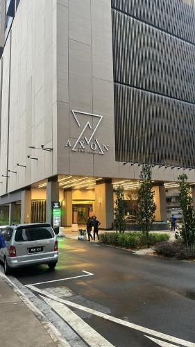 a car parked in a parking lot in front of a building at Crystal Suites at Axon Residence near Pavilion in Kuala Lumpur