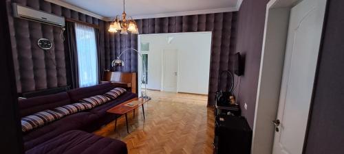 a living room with a couch and a table at Guest House Pirosmani 60 in Sighnaghi