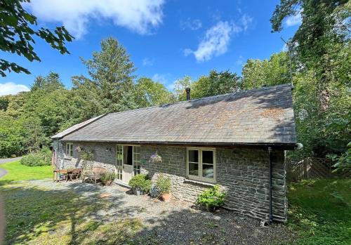 a stone cottage in the middle of a yard at Drovers Retreat in Llandrindod Wells