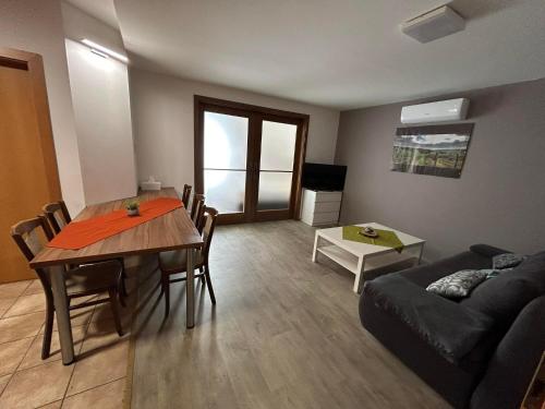 a living room with a table and a couch at Apartmány Formanka na náměstí in Hustopeče