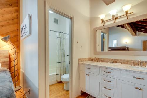 a bathroom with a sink and a toilet and a mirror at Brian Head Vacation Rental Walk to Giant Steps! in Brian Head