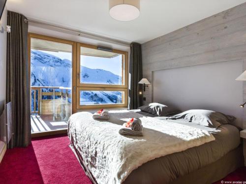 a bedroom with a large bed and a large window at Chalet Avoriaz, 5 pièces, 10 personnes - FR-1-314-113 in Avoriaz