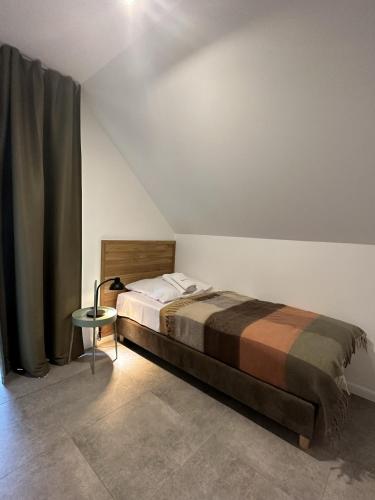 a bedroom with a bed and a table in it at Młynowiec 4Rest in Stronie Śląskie