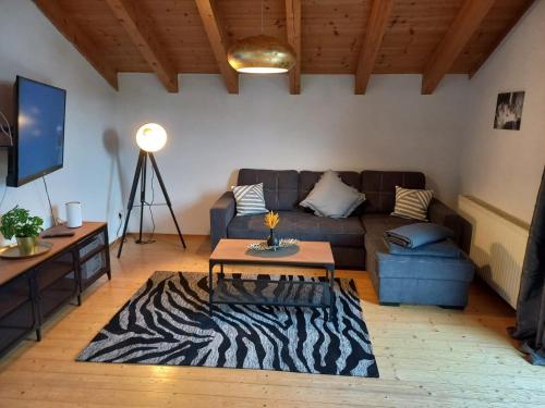 a living room with a couch and a zebra rug at Lechapart Wagner in Reutte