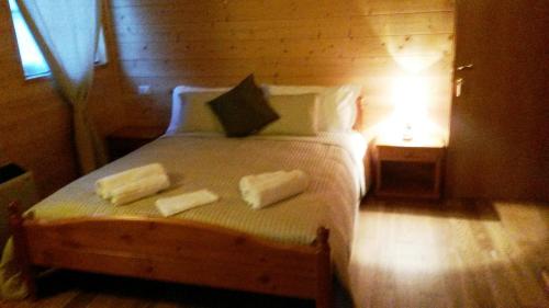 a bedroom with a bed with two towels on it at Locanda Aquila Bianca in Valprato Soana