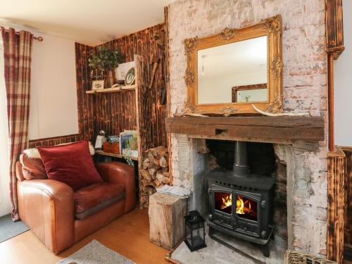 a living room with a fireplace and a mirror at 1 Slatach in Glenfinnan
