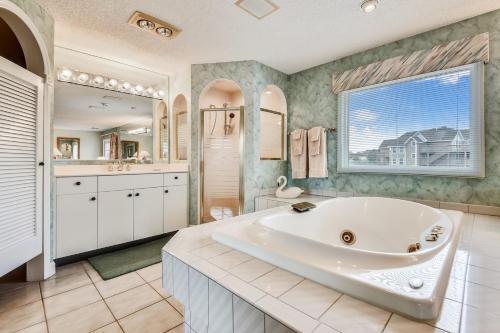 a large bathroom with a large tub and a sink at The Tappan at Ships Watch in Duck