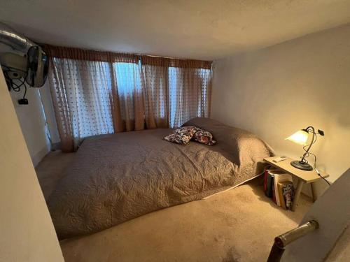 a bedroom with a bed and a lamp and a window at Λαγκάδι Μάνης in Koíta