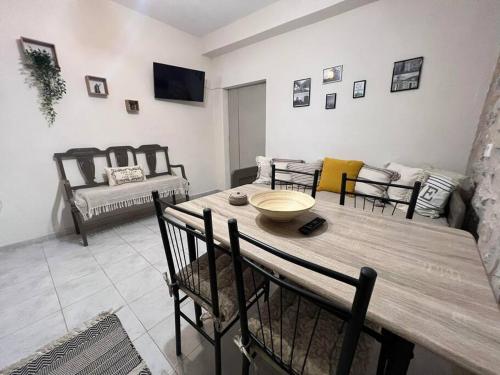 a living room with a table and chairs and a couch at Λαγκάδι Μάνης in Koíta