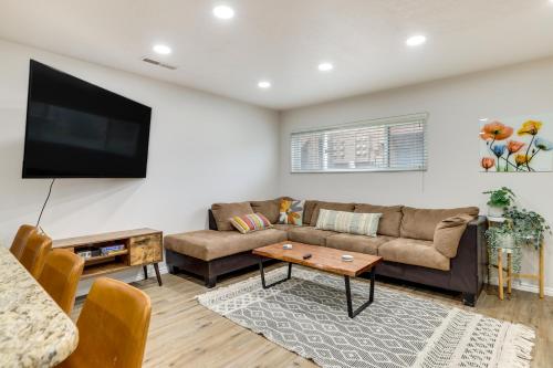 a living room with a couch and a flat screen tv at Modern Condo in St Georges Sports Village in St. George