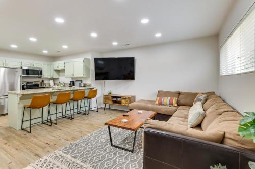 a living room with a couch and a kitchen at Modern Condo in St Georges Sports Village in St. George