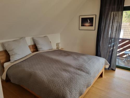 a bedroom with a large bed and a window at Rurstübchen in Simmerath