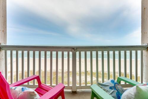 a balcony with chairs and a view of the beach at Beachfront Corpus Christi Condo with Pool Access! in Corpus Christi