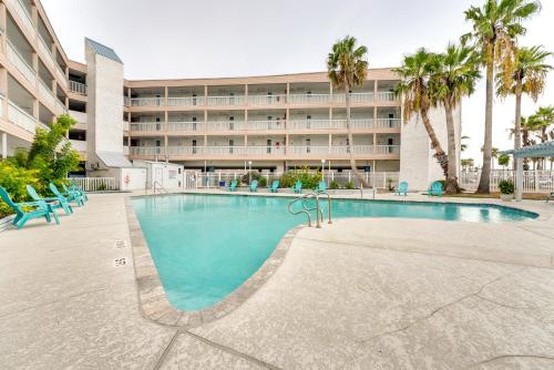 a large swimming pool in front of a hotel at Beachfront Corpus Christi Condo with Pool Access! in Corpus Christi