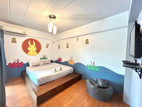 a bedroom with a bed and a tv at Hide Bangkok Hostel in Bangkok