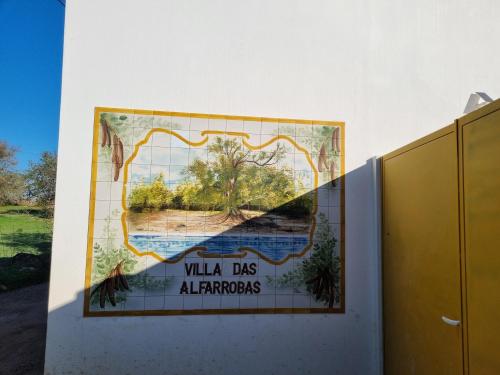 a large mural on the wall of a building with a painting at Eco Cabin - Villa das Alfarrobas in Algoz