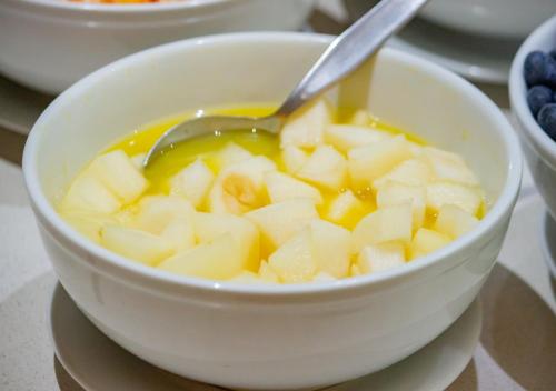 a bowl of soup with a spoon in it at Aku Hotels in Lima
