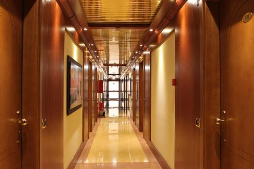 a corridor of a building with wooden walls and wooden floors at Best Western Hotel Anthurium in Santo Stefano al Mare
