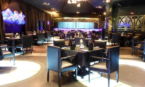 a restaurant with tables and chairs in a room at The Ashok, New Delhi in New Delhi