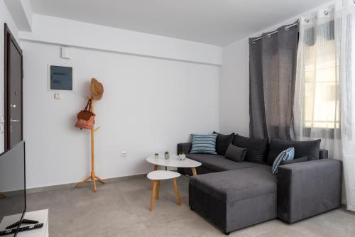 a living room with a couch and a table at PROPAN CITY SUITES in Volos