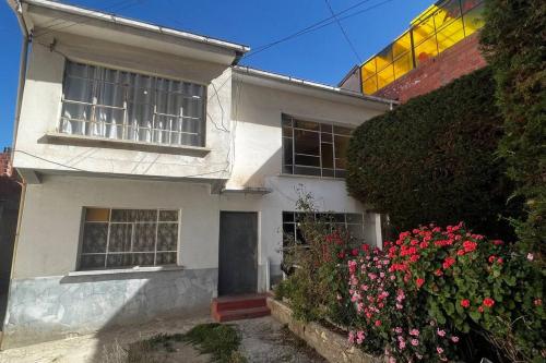 a white house with flowers in front of it at Don Julio’s House in La Paz