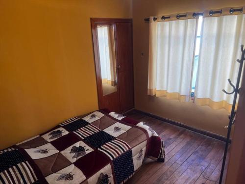 a bedroom with a bed with a quilt on it at Don Julio’s House in La Paz